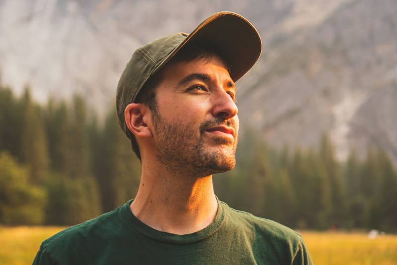 Man in cap and green shirt