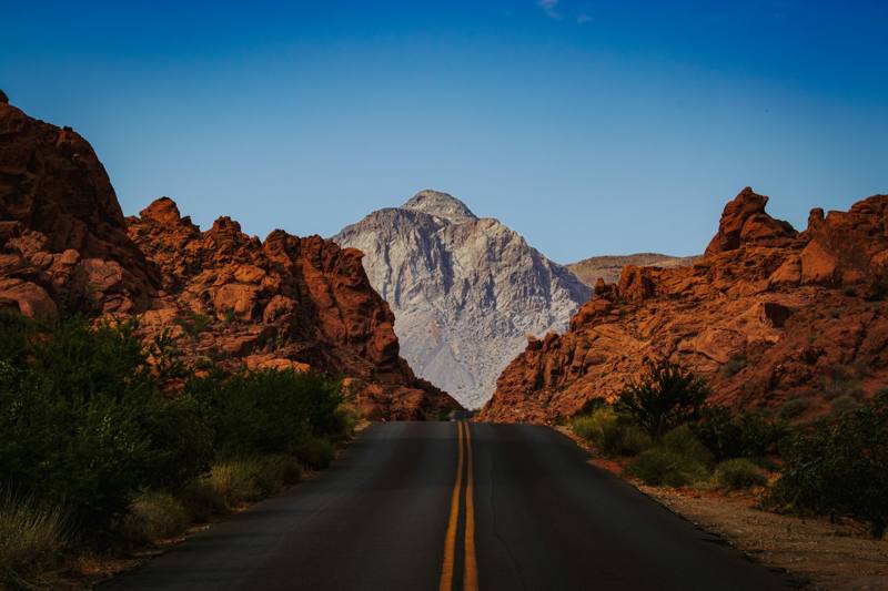 A road with a mountain in the background